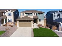 Inviting two-story home with a two car garage, well-manicured lawn, and charming curb appeal at 944 Mcmurdo Cir, Castle Rock, CO 80108