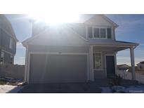 Two-story house with gray siding, attached garage, and small front yard at 20108 Randolph Pl, Denver, CO 80249