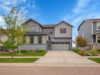 Charming two-story home with a well-manicured lawn, attached two car garage, and beautiful landscaping at 7012 S Undergrove Way, Aurora, CO 80016