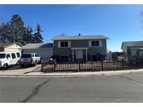 Charming two-story home featuring a well-manicured front yard, attached garage, and inviting entrance at 8820 Cody St, Broomfield, CO 80021