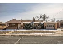 Charming single-story brick home featuring a well-maintained lawn and a detached garage at 1330 E 90Th Ave, Thornton, CO 80229