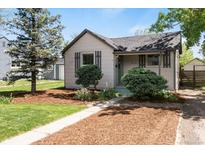 Charming single-Gathering home featuring a well-maintained front yard with mature landscaping and inviting curb appeal at 4712 Perry St, Denver, CO 80212