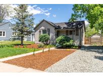 Charming single-story home with landscaped front yard and gravel driveway at 4712 Perry St, Denver, CO 80212