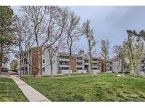 A view of the exterior of the apartment building with brick and painted wood at 14437 E 1St Dr # C09, Aurora, CO 80011