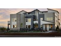 Modern three-story home with stone accents and landscaped yard at 2515 W 69Th Pl, Denver, CO 80221