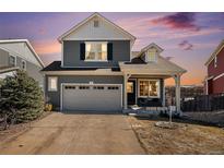 Charming two-story home featuring well-maintained landscaping, attached garage, and inviting front porch at 1698 Odyssey Ct, Castle Rock, CO 80109