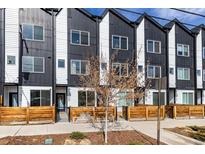 Modern townhome exteriors showcase black and white siding, a small tree, and wood accents at 4925 W 10Th Ave # 111, Denver, CO 80204