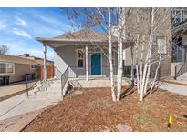 Charming home exterior with a welcoming front porch and vibrant blue door at 1267 Quitman St, Denver, CO 80204