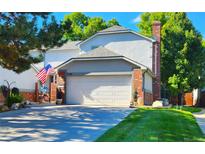 Two-story home with attached garage and landscaped yard at 5109 S Emporia Way, Greenwood Village, CO 80111