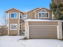 Charming two-story home featuring a brick accent, arched window and an attached two car garage in a quiet neighborhood at 3948 S Halifax St, Aurora, CO 80013