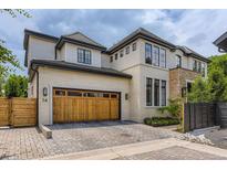 Beautiful home with a wooden garage door, paver driveway, and appealing architectural details at 2821 E Cedar Ave # 14, Denver, CO 80209