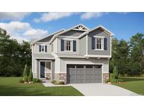 Charming two-story home with gray siding, stone accents, and well-maintained lawn at 9276 Telluride Ct, Commerce City, CO 80022