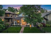 Charming home with a manicured lawn, covered porch, and mature trees, showcasing curb appeal at 2340 S Columbine St, Denver, CO 80210