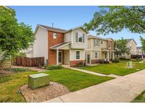 Charming townhome with well-manicured lawn and inviting entrance at 10700 Kimblewyck Cir # 155, Northglenn, CO 80233