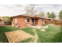 Spacious backyard with manicured lawn, garden area, and patio at 5190 E Asbury Ave, Denver, CO 80222