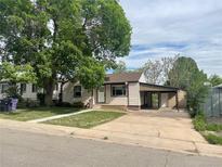 Charming single-story home with a large shade tree and a covered carport, offering convenient parking at 2625 W Ellsworth Ave, Denver, CO 80219