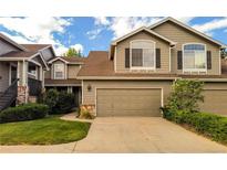 Inviting two-story home with a well-maintained lawn and a spacious two-car garage at 6407 S Dallas Ct, Englewood, CO 80111
