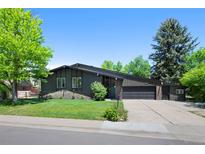 Charming single-Gathering home with an attached garage, lush front lawn and mature shade trees in a serene setting at 5265 W Quarles Dr, Littleton, CO 80128