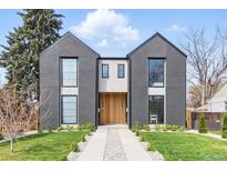 Stunning modern home featuring a gray exterior, natural wood accents, large windows, and professional landscaping at 2961 S Cherokee, Englewood, CO 80110