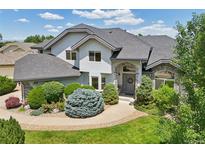 Stately home featuring lush landscaping, a stone-accented entrance, and a well-manicured lawn at 2247 Eagles Nest Dr, Lafayette, CO 80026