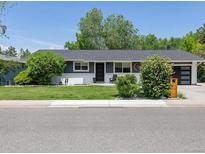 Charming single-story home with a well-manicured lawn, updated garage door and mature landscaping at 1333 W Peakview Ave, Littleton, CO 80120