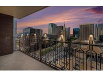 A balcony with a view of the city skyline at sunset at 1020 15Th St # 18I, Denver, CO 80202