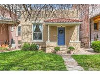 Charming home featuring a blue front door, red-tiled roof, and well-maintained lawn at 2222 N Williams St, Denver, CO 80205