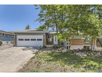 Charming single-story home featuring a brick facade, two car garage, and xeriscaped front yard at 540 Ithaca Dr, Boulder, CO 80305