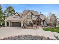 Charming two-story home featuring a well-maintained front yard, a concrete driveway, and an attached garage at 4 White Fir Ct, Littleton, CO 80127