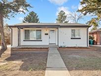 Charming single-story home with a white exterior, clean landscaping, and a welcoming front entrance at 1475 S Eaton St, Lakewood, CO 80232