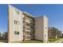 Exterior view of three-story condo building with private wooden balconies and well-maintained lawn at 8450 Decatur St # 97, Westminster, CO 80031