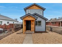 Charming two-story home with new gray siding, wood accents, and rock landscaping at 71 S Quitman St, Denver, CO 80219