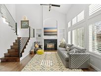 Bright living room with a fireplace, large windows, and elegant decor creating a cozy and inviting space at 2545 Andrew Dr, Superior, CO 80027
