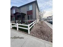 Charming townhome featuring a fenced yard with cozy outdoor seating area at 1353 Reynolds St # 5A, Fort Lupton, CO 80621
