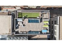 Aerial view of a spacious rooftop deck featuring outdoor seating, green turf, and lounging areas at 1449 Wynkoop St # 601, Denver, CO 80202