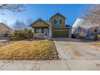 Charming two-story home featuring a well-manicured lawn and an attached two-car garage at 11405 Iola St, Commerce City, CO 80640
