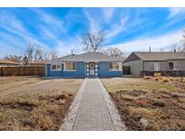 Charming blue single-story home featuring a paved walkway, manicured lawn, and inviting curb appeal at 2930 Oneida St, Denver, CO 80207