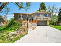 Charming split-level home featuring a newly built deck and attached two-car garage at 7448 W Geddes Pl, Littleton, CO 80128