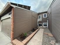 Charming home exterior featuring a well-maintained yard and inviting walkway at 6921 S Bryant St, Littleton, CO 80120