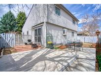 Inviting backyard with a patio, deck, and outdoor seating area for relaxation and entertaining at 1834 Hennington Ct, Longmont, CO 80501