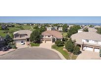 Expansive suburban homes showcase lush landscaping, cul-de-sac, and scenic mountain views at 10085 Charissglen Ct, Highlands Ranch, CO 80126