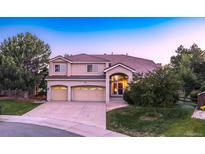 Beautiful two-story home featuring a three-car garage and mature landscaping at 10085 Charissglen Ct, Highlands Ranch, CO 80126