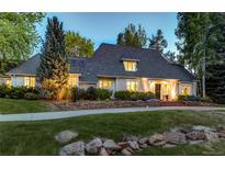 Stately two-story home with lush landscaping and elegant stone accents along the front yard at 1512 Cottonwood Ln, Greenwood Village, CO 80121