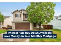 Charming two-story home boasts a well-manicured lawn and a cozy front porch at 13504 Pecos St, Westminster, CO 80234