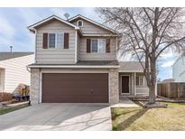 Charming two-story home featuring a spacious garage, well-maintained lawn, and inviting front porch at 13504 Pecos St, Westminster, CO 80234