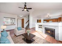 Inviting living room with a cozy fireplace, vaulted ceiling, and ample natural light at 13504 Pecos St, Westminster, CO 80234