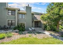 Charming townhouse showcasing a welcoming front exterior, landscaped yard, and inviting entrance with seating at 19 Benthaven Pl, Boulder, CO 80305