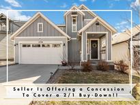 Charming two-story home featuring a well-manicured lawn, a cozy front porch and a two car garage at 27798 E 7Th Pl, Aurora, CO 80018