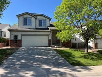 Charming two-story home with a two car garage and landscaped front yard at 20558 E Grand Ln, Aurora, CO 80015
