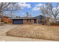 Cozy single-Gathering home boasting a brick facade, attached garage, and well-maintained lawn at 3465 E Arapahoe Pl, Centennial, CO 80122